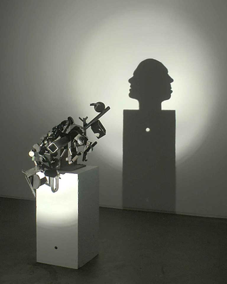 Illustration for article titled Gruesome shadow art transforms garbage and mummified rats into severed heads